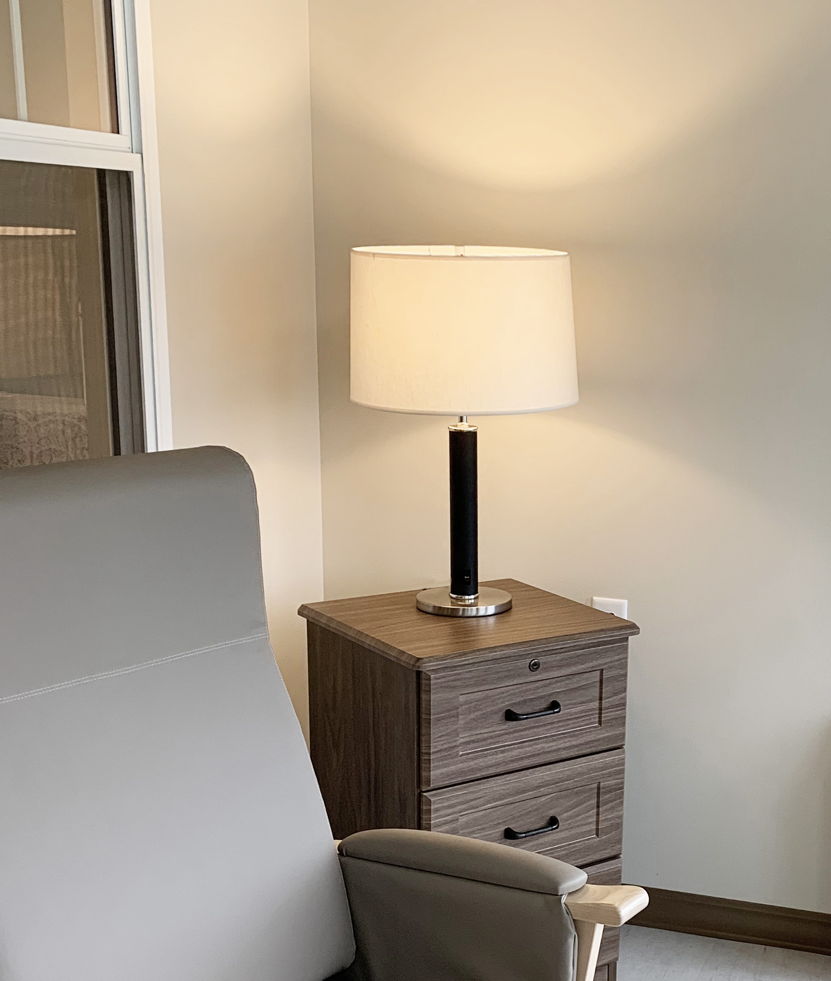 Multihousing room with JES lamp on nightstand